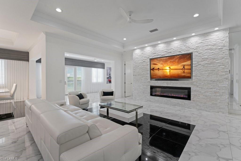 Living space featuring a stacked stone accent wall with an integrated electric fireplace