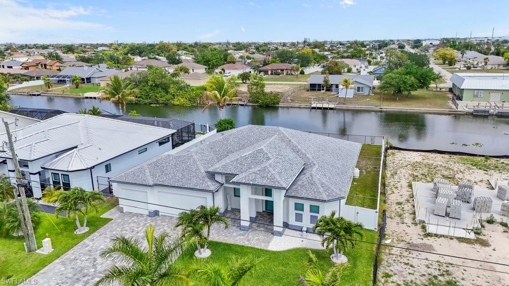 Modern single-story residence featuring a gray shingle roof and white exterior
