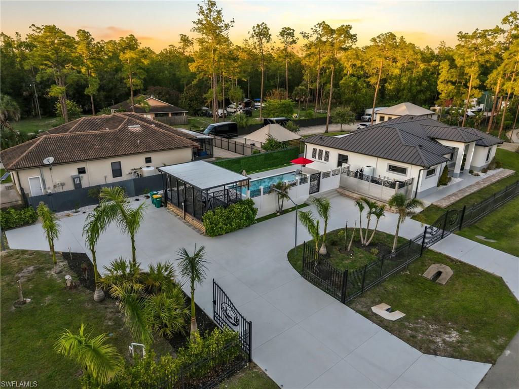 Contemporary residence featuring a dark metal roof and light-colored exterior