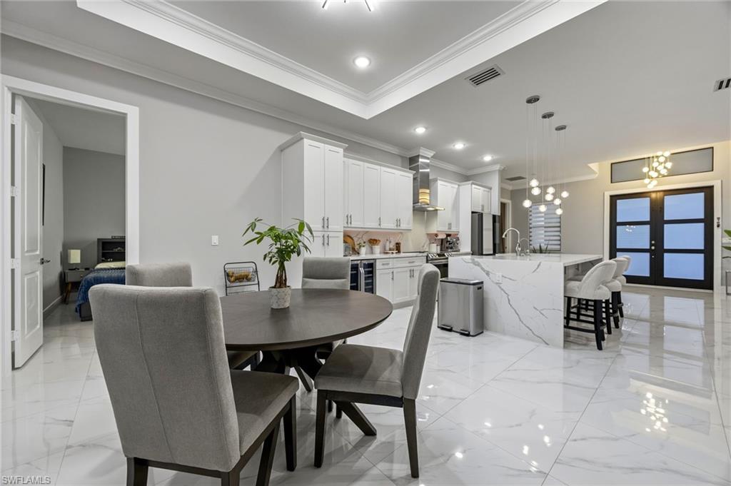 Dining area featuring crown molding, and recessed lighting