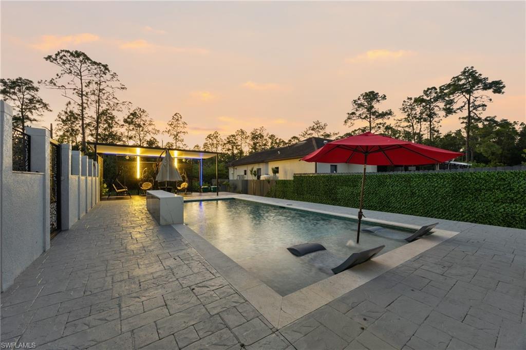 Expansive stamped concrete patio surrounding a rectangular swimming pool