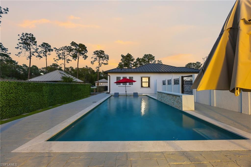 Rectangular swimming pool featuring a light-toned coping and surrounding patio