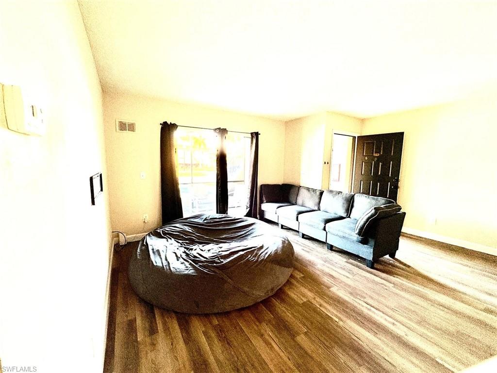 Living room with wood finished floors and baseboards