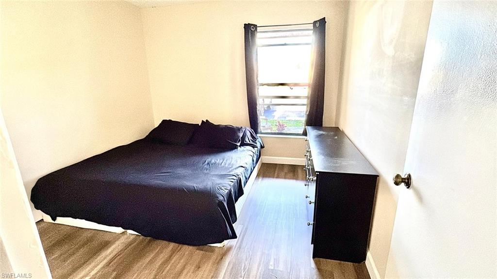 Bedroom featuring baseboards and wood finished floors