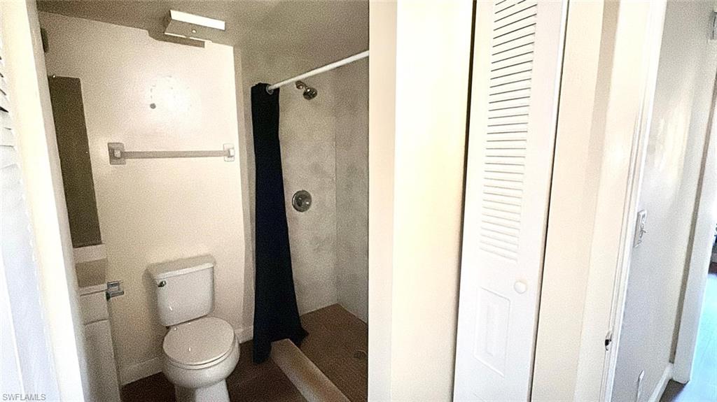 Full bath with a closet and a shower stall