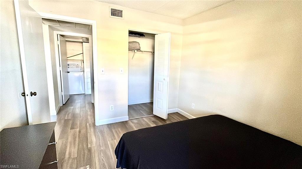 Bedroom featuring wood finished floors and a closet