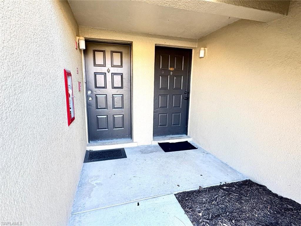 View of exterior entry with stucco siding