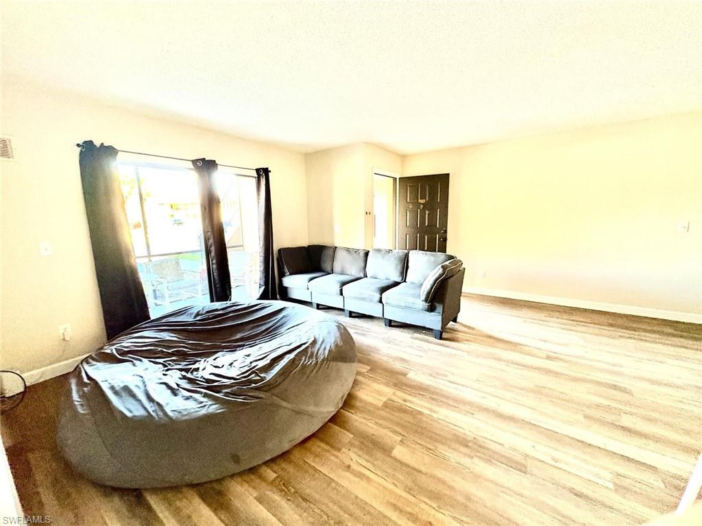 Living room featuring wood finished floors and baseboards