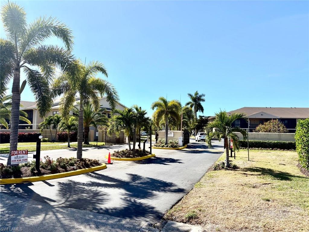 View of asphalt road with a gated entry