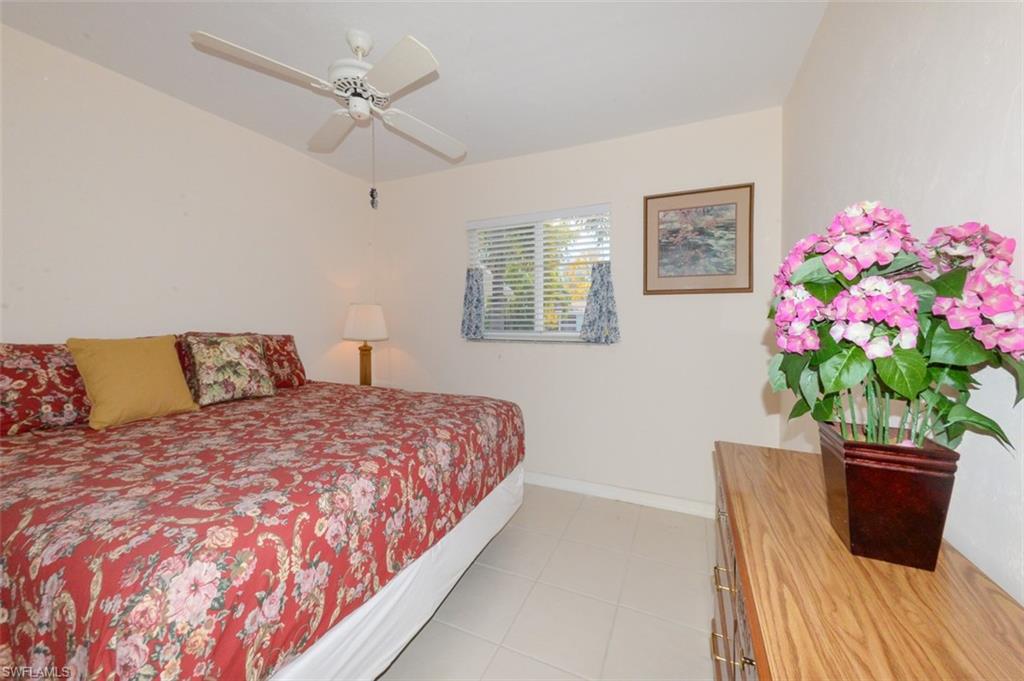 Guest bedroom with large tile flooring.