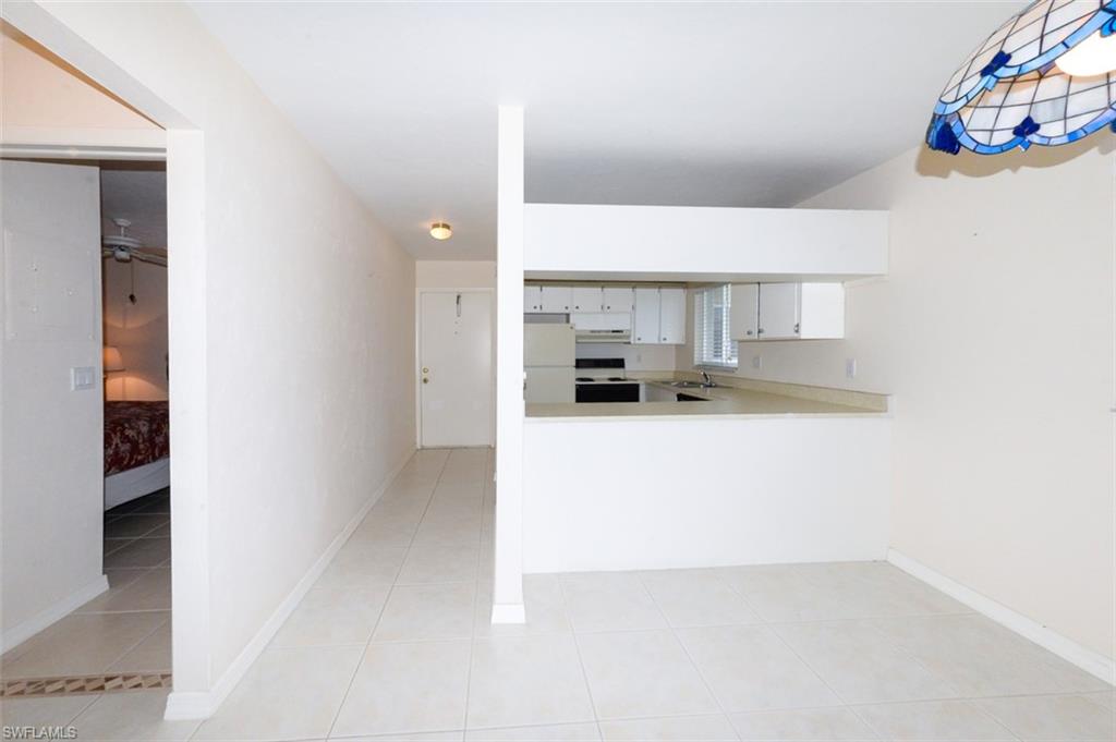 Entry Foyer and kitchen from the living room. Shows guest bedroom to the left.