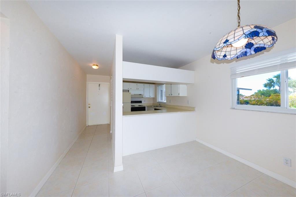 Entry Foyer and kitchen from the living room. Shows large living room window.