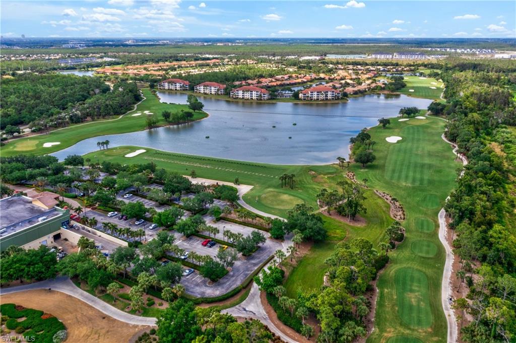 Aerial view of the beautifully maintained golf course in Pelican Preserve showcasing lush fairways and scenic landscaping.