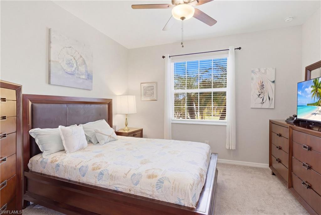 Comfortable guest bedroom offering a bright, inviting space with ample natural light and a clean, neutral design.