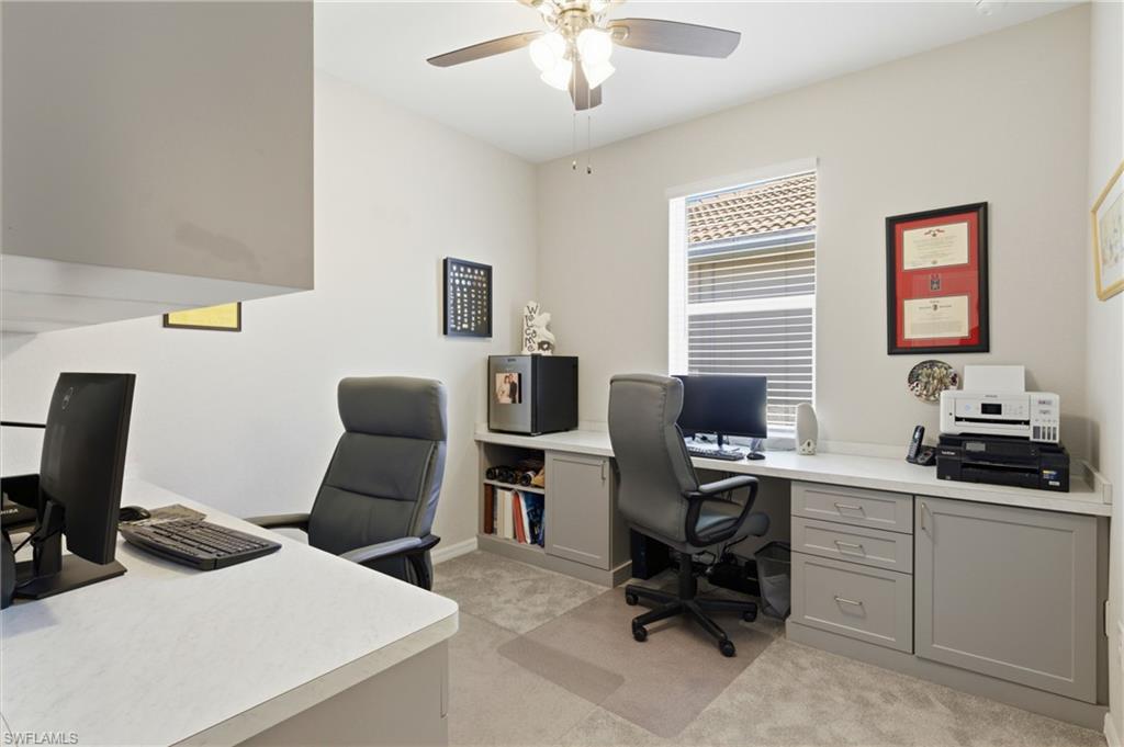 Custom home office with built-in desks and upper and lower cabinetry, perfect for working from home.