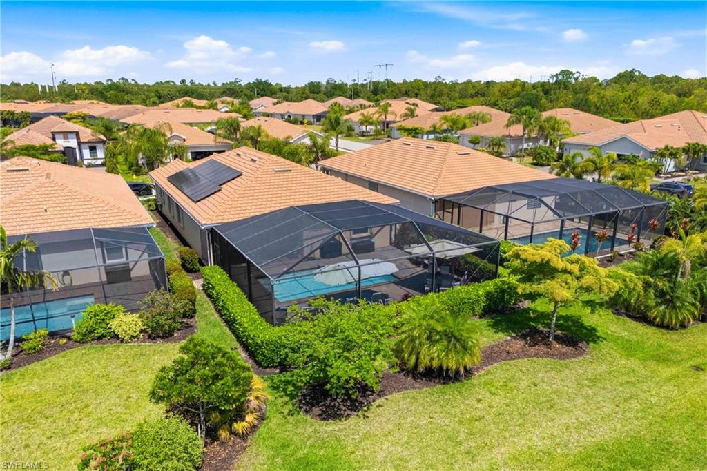 Beautiful backyard aerial view showcasing resort-style living with a pool and calming lake views.