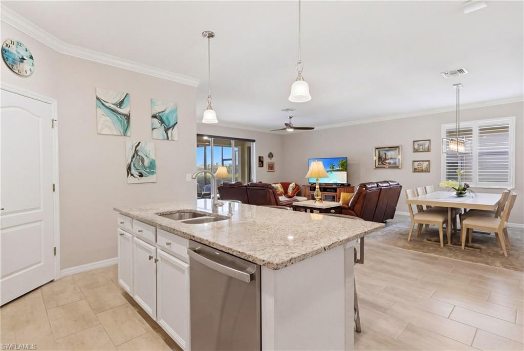 Beautiful kitchen featuring granite countertops, modern appliances, and a spacious walk-in pantry for exceptional storage.