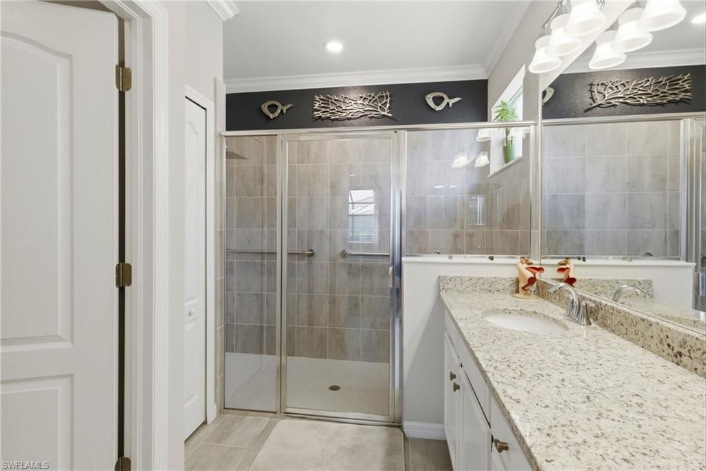 Elegant primary bathroom offering a generous walk-in shower and a functional, open layout.