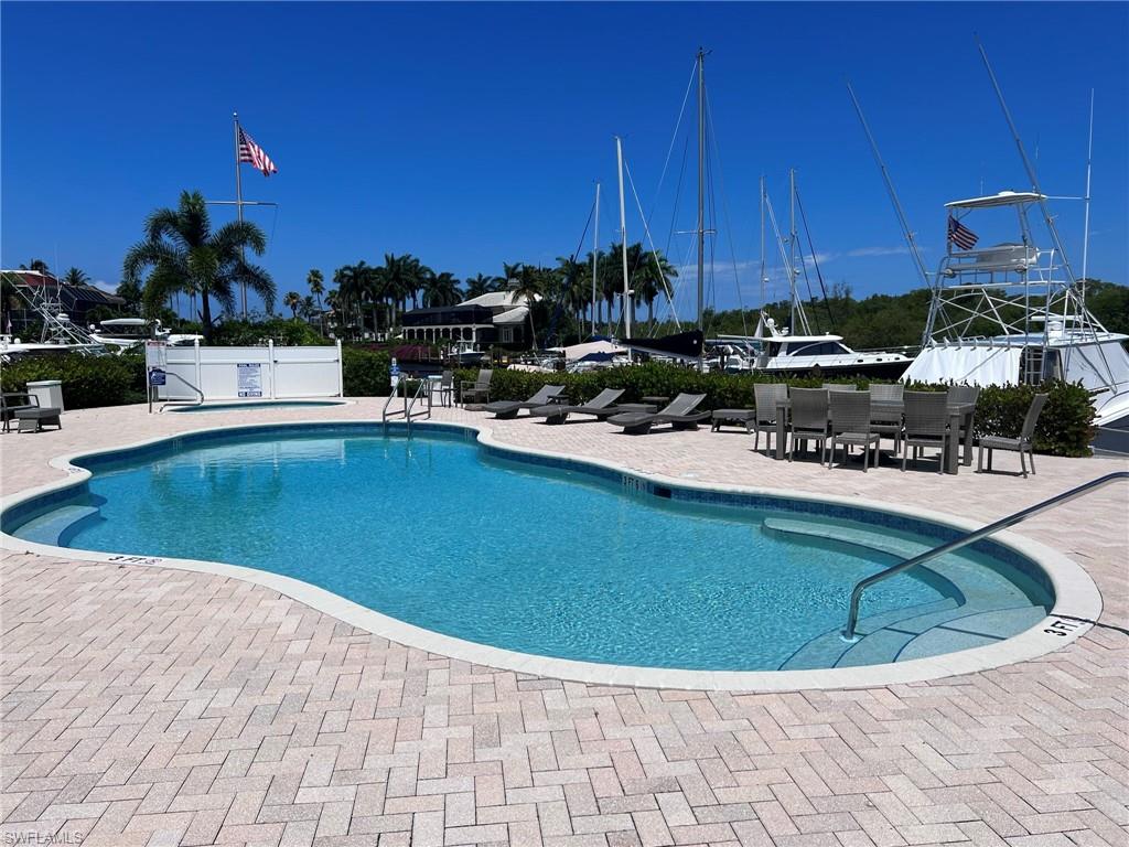 Freeform swimming pool surrounded by a paver deck
