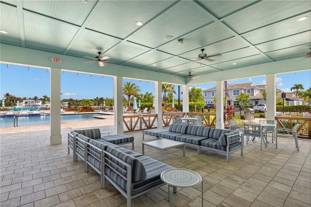 Covered outdoor patio area featuring a coffered ceiling with recessed lighting and ceiling fans