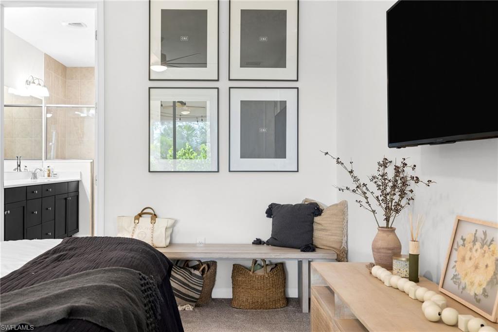 Spacious room featuring neutral carpeting and a wall-mounted display