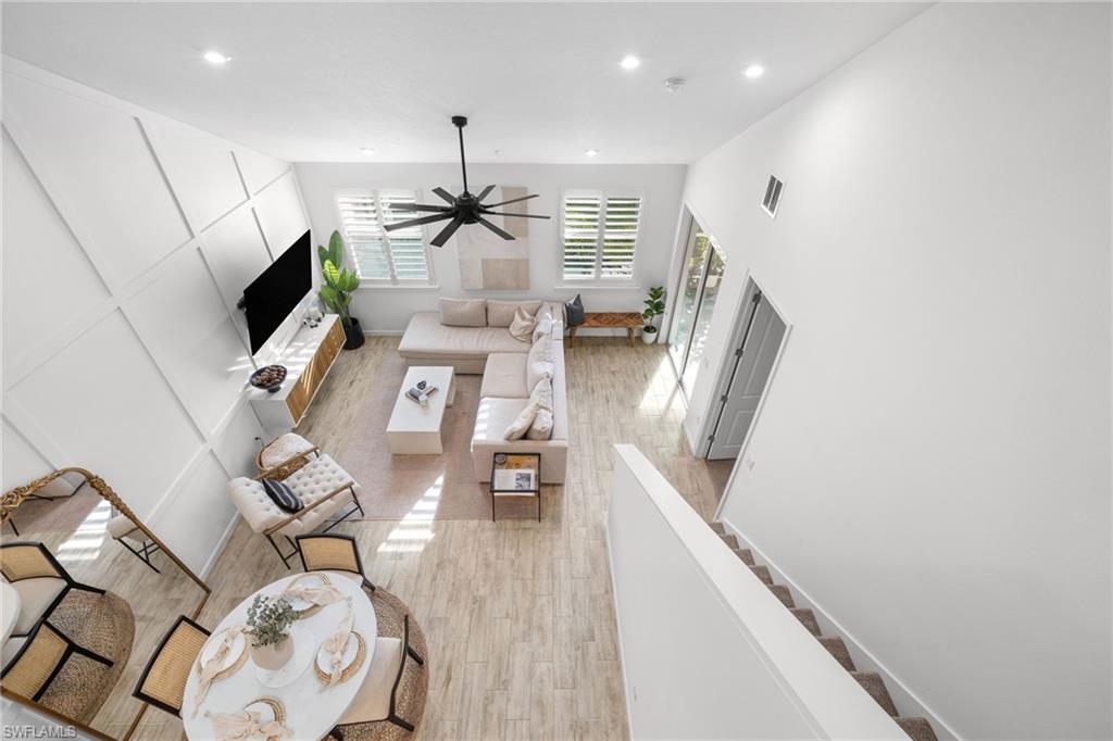 Expansive living area featuring soaring ceilings and wood-finish flooring