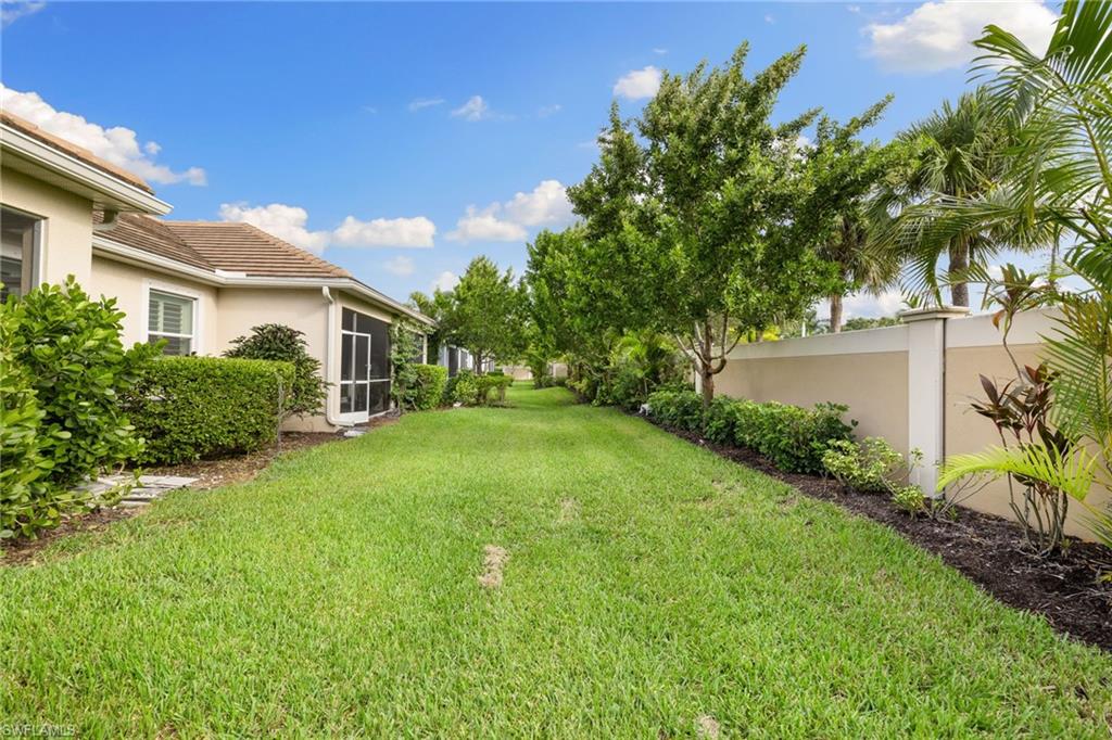 Expansive green lawn bordering a stucco exterior with a tiled roof