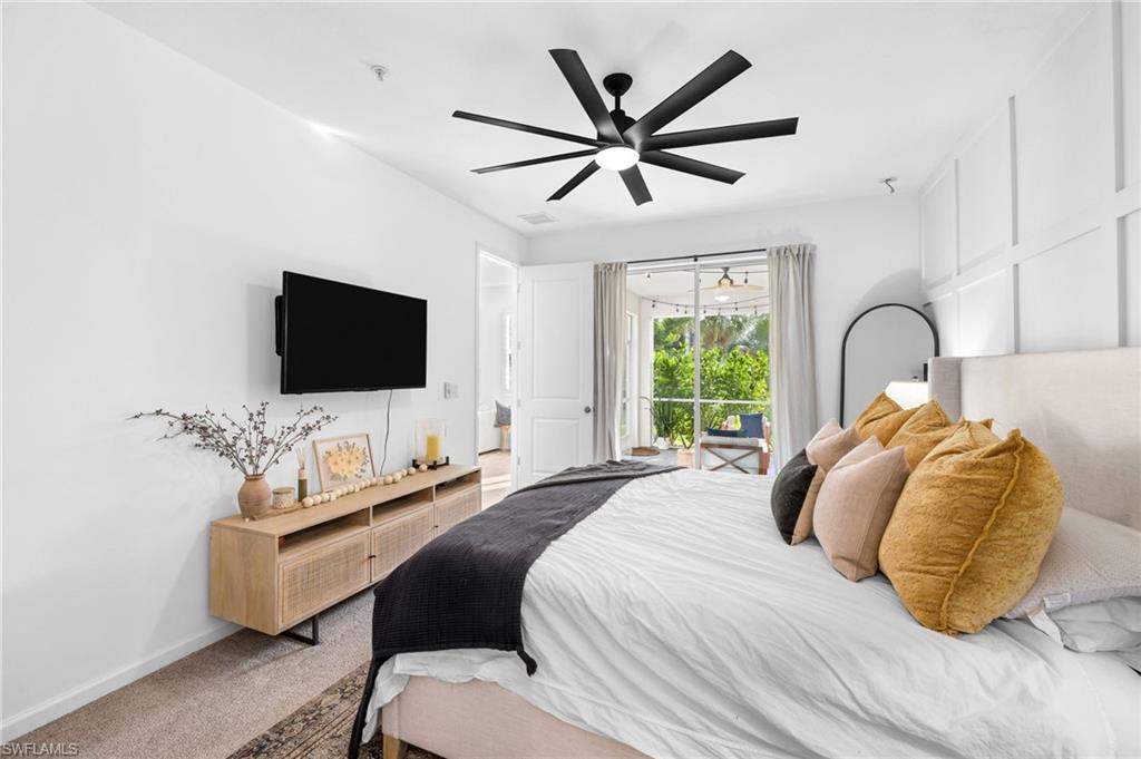 Bright interior space featuring a multi-blade ceiling fan, recessed lighting, white board and batten wall accent, and a sliding glass door with exterior access