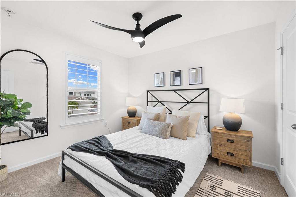 Interior space featuring white walls and a ceiling fan with integrated lighting