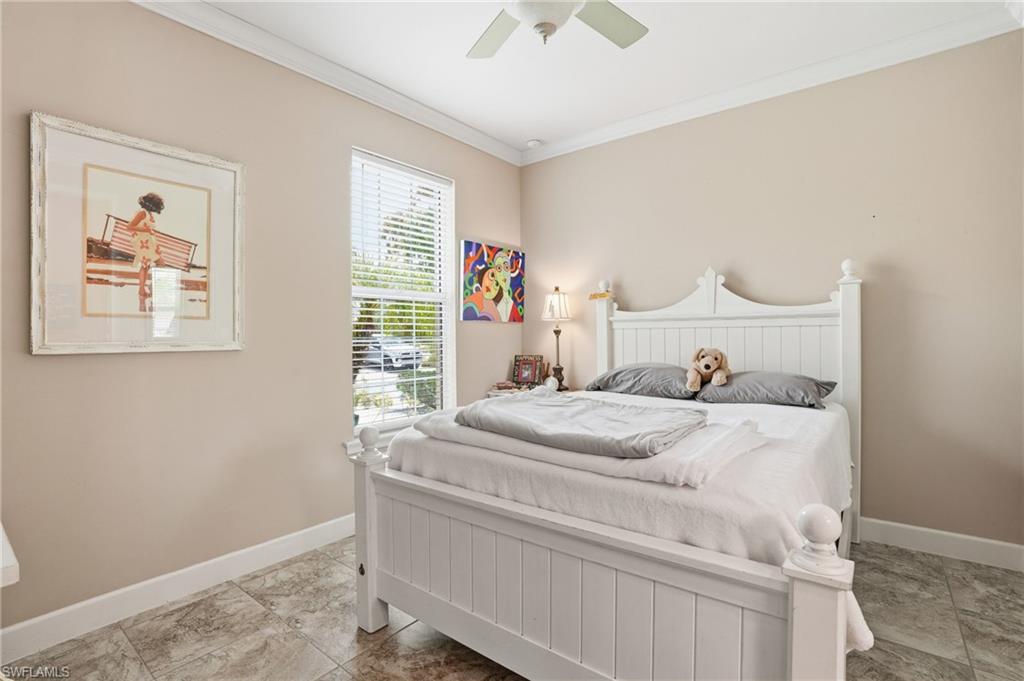 Bright room featuring a window with blinds, a ceiling fan, crown molding, tile flooring, and neutral wall paint