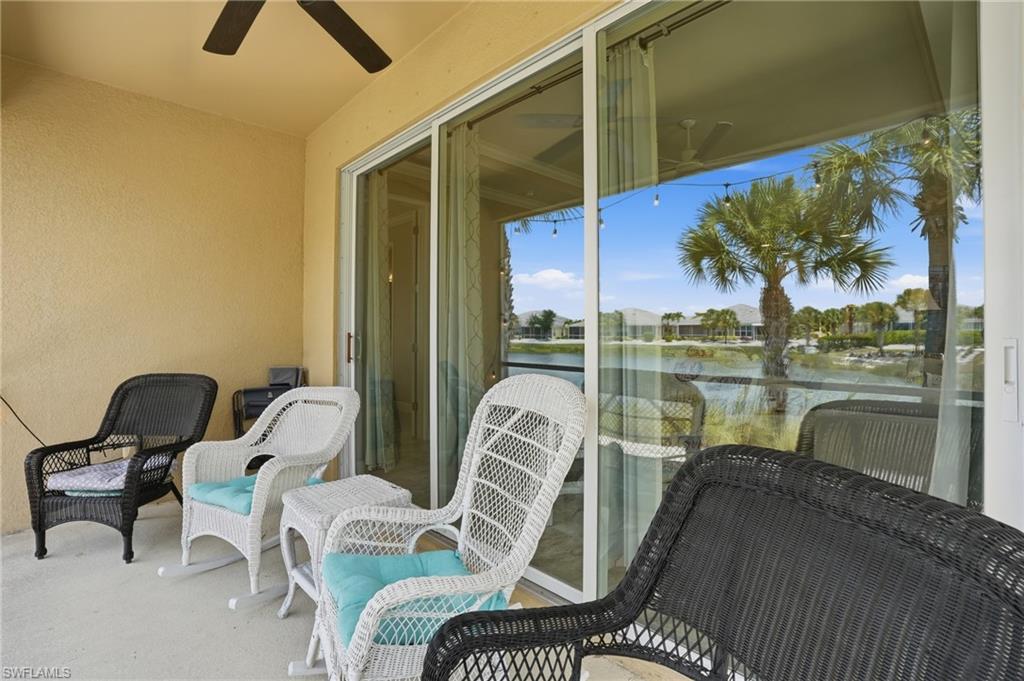 Covered patio with expansive sliding glass doors, featuring a ceiling fan and textured stucco walls