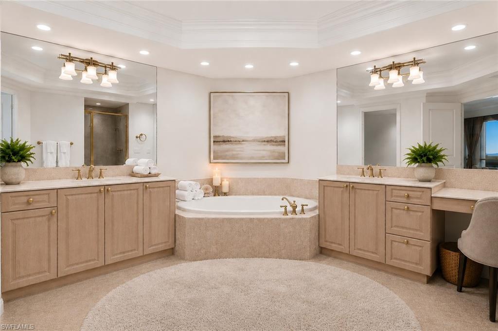 Primary ensuite with soaking tub and separate vanity areas.