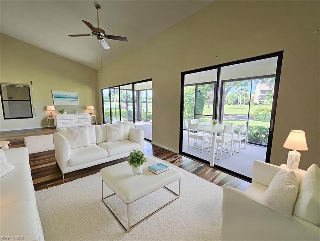 VIRTUALLY STAGED Great Room w/White Modern Furniture & Brazilian Pecan Flooring facing Lanai & Golf Course- View 5