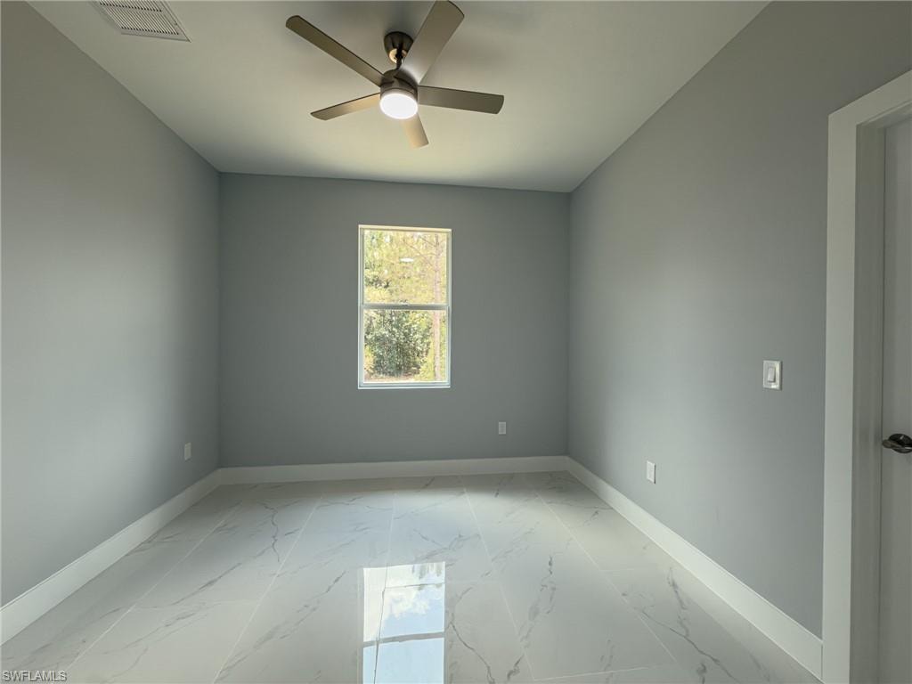 2nd Bedroom with ceiling fan, visible vents, marble finish floor, and baseboards