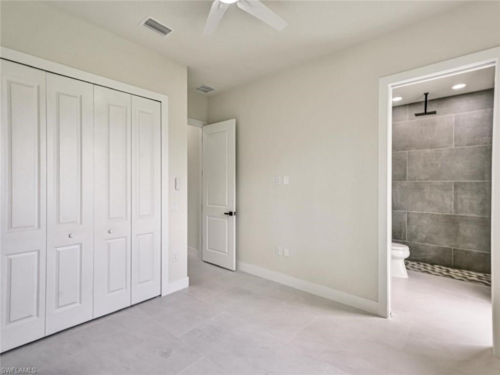 Interior space featuring light-toned walls and large format tile flooring