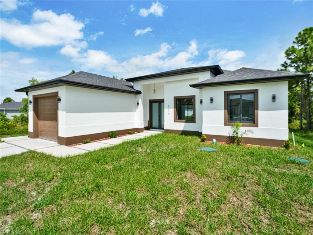 Contemporary stucco exterior with a dark trim and a single-car garage