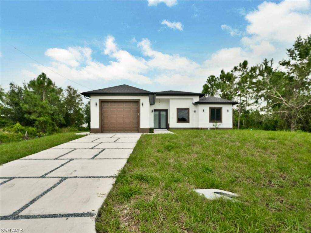 Contemporary white stucco exterior with a dark roof and brown garage door