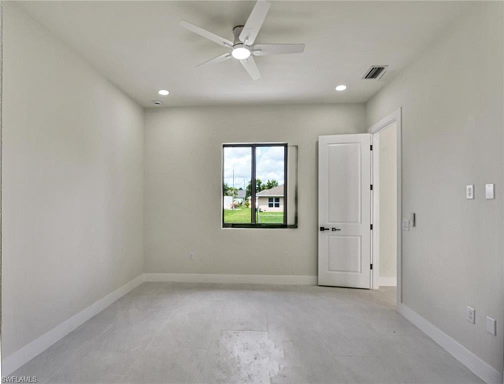 Spacious room featuring light-toned flooring, recessed lighting, and a contemporary ceiling fan