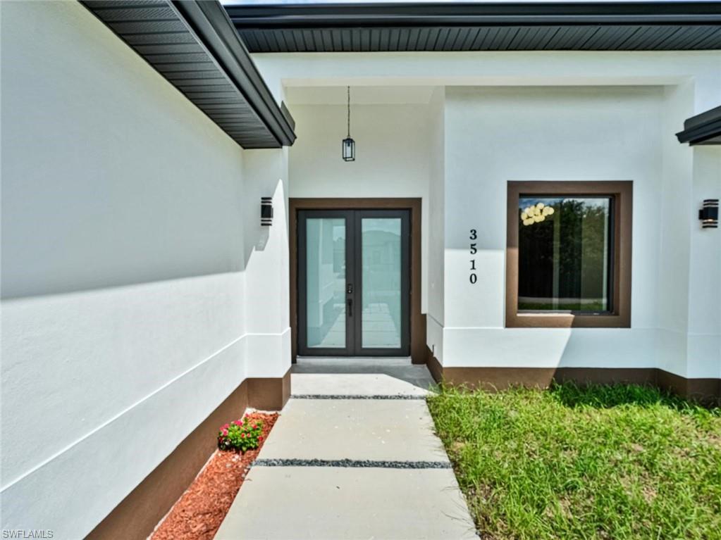 Contemporary exterior with white stucco finish and contrasting brown accents