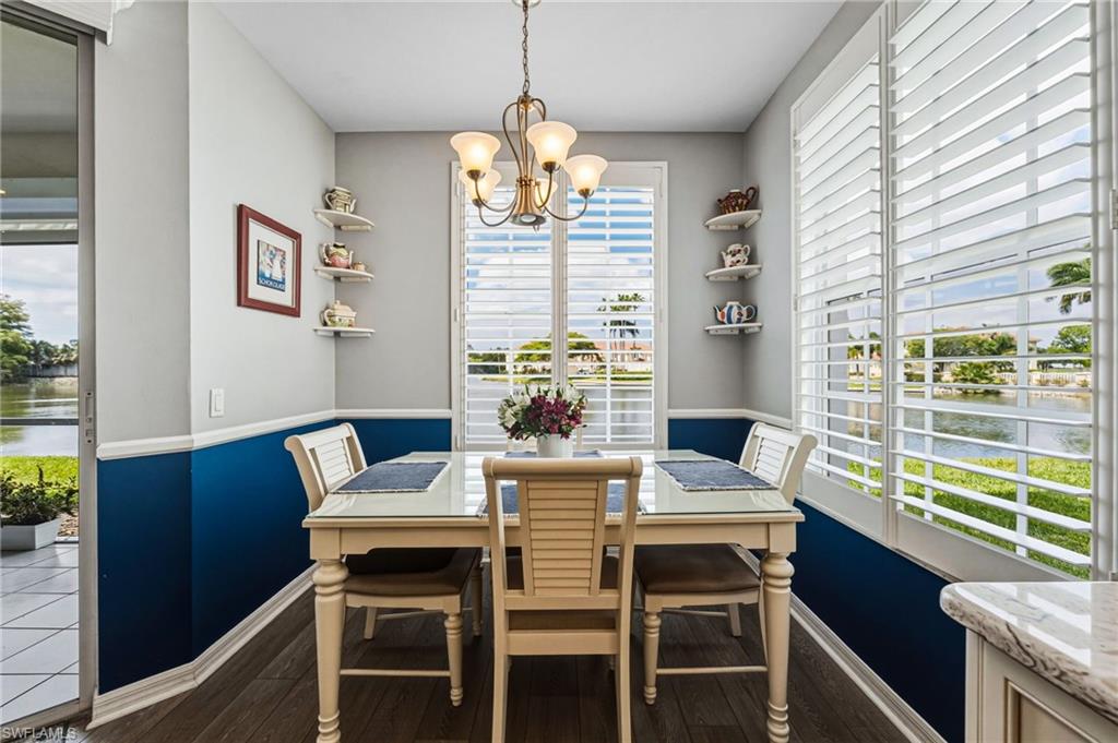 The breakfast area is bathed in natural light, further enhanced by elegant plantation shutters and refined chair railing, creating a warm yet sophisticated ambiance. This highly sought-after Sandpiper floorplan is distinguished by additional windows and expanded square footage, offering a more spacious and luminous living experience.