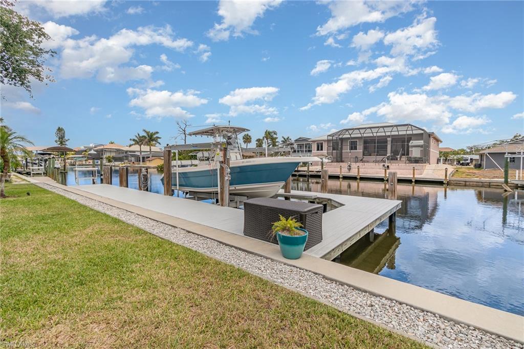 Seeing is believing! 75' Seawall on a wide canal! Heavy duty boat lift & wrap-a-round composite dock!