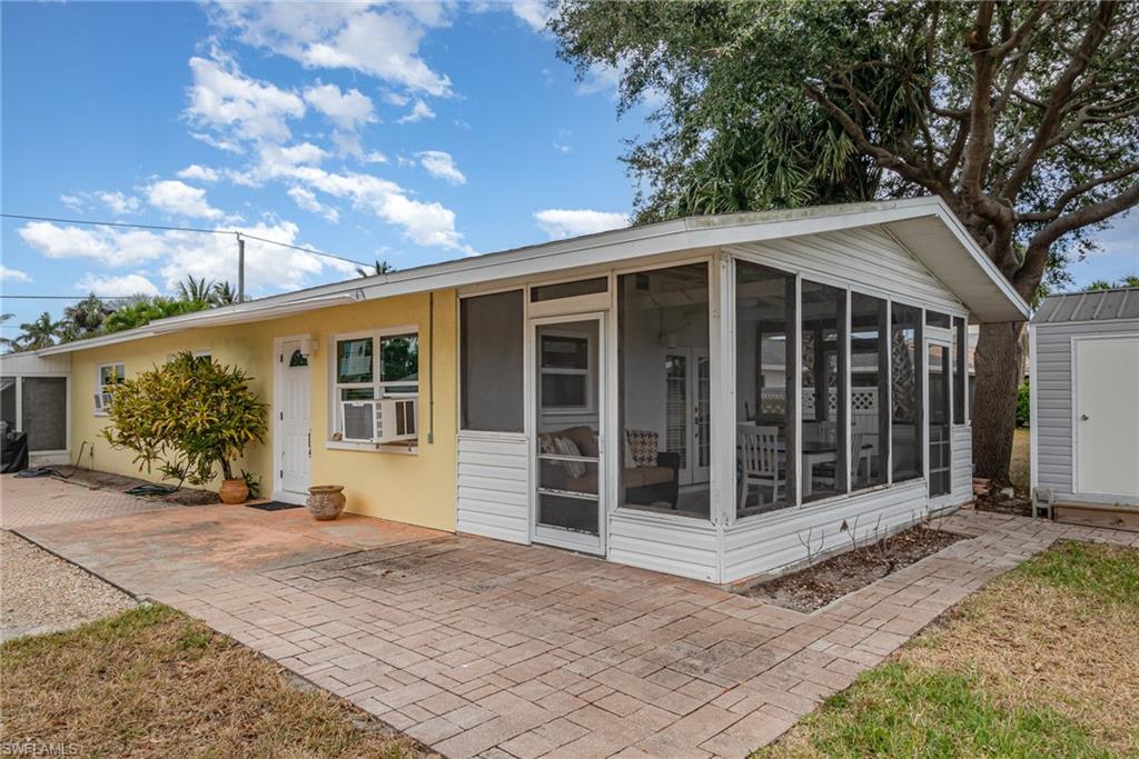 The yellow stucco exterior is highlighted by white entry doors and windows!
