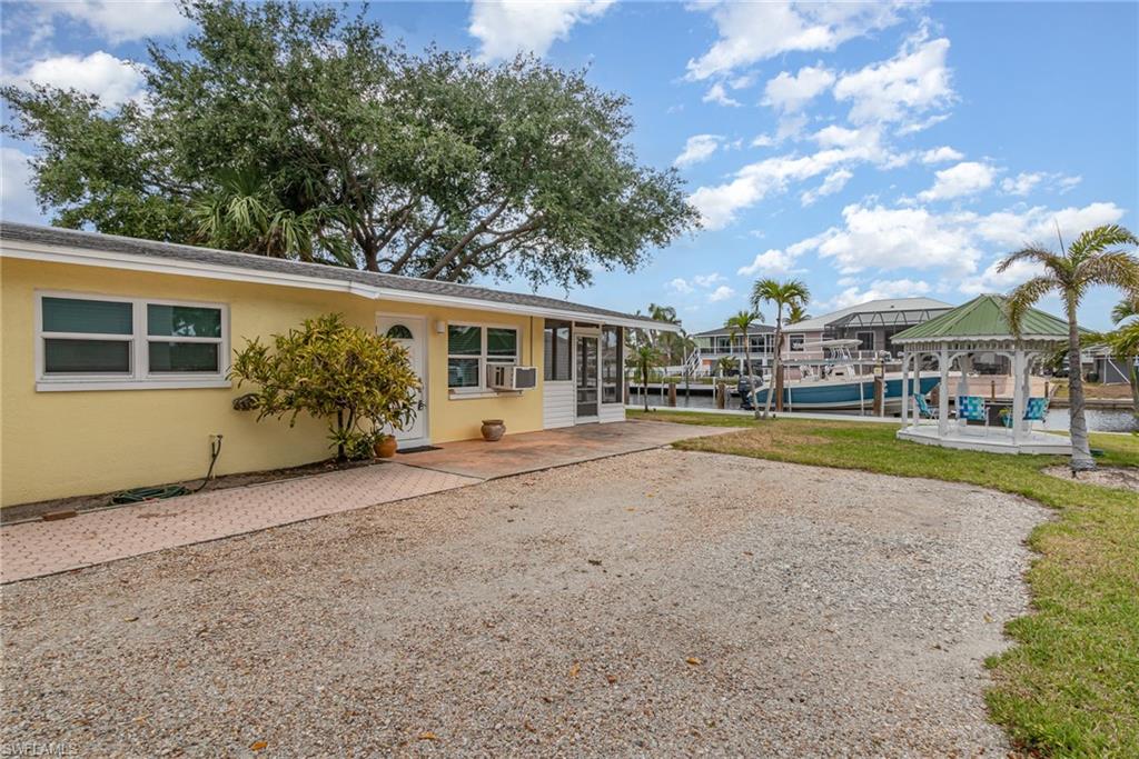 Surrounding the parking area is a gazebo and mature palm trees!