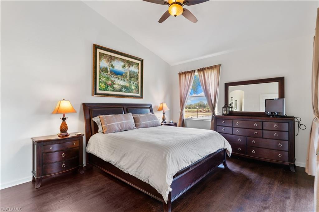 Bedroom featuring lofted ceiling, dark wood-type flooring, and a ceiling fan