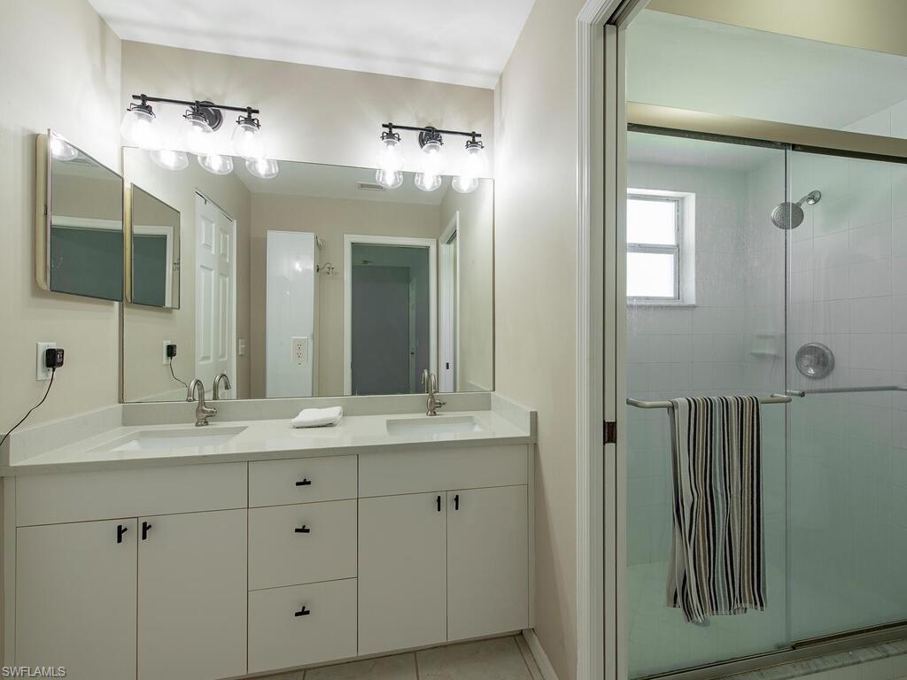 Primary bathroom with double sinks and walk in shower