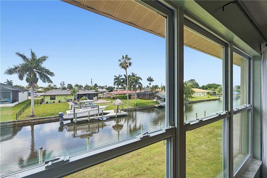 Living room view through new windows of canal wildlife includes manatees, dolphins, fish, and birds!
