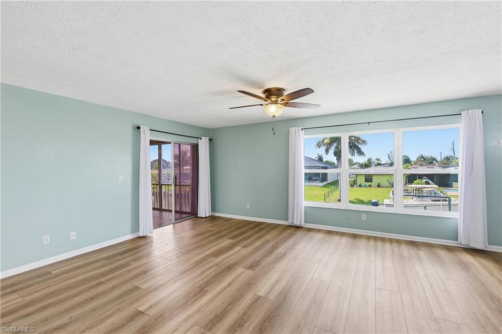 Beautiful new, tilt in, living room windows are impact resistant for protection in storms and to reduce noise. Sliders on left provide access to all season lanai and back stairway.