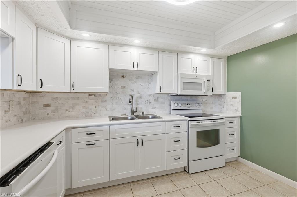 Updated kitchen features sleek appliances, all new cabinets with multiple drawers and decorator wood tray ceiling.