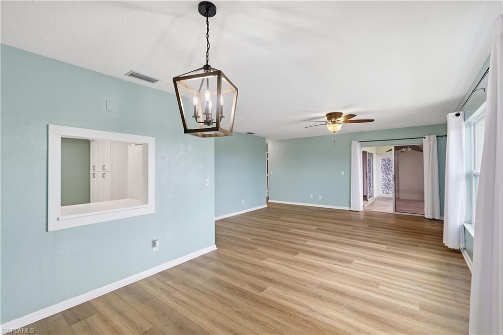 Dining room has easy access to kitchen via the pass-through and is open to the living room. The slider accesses the lanai and stairway out the back door.