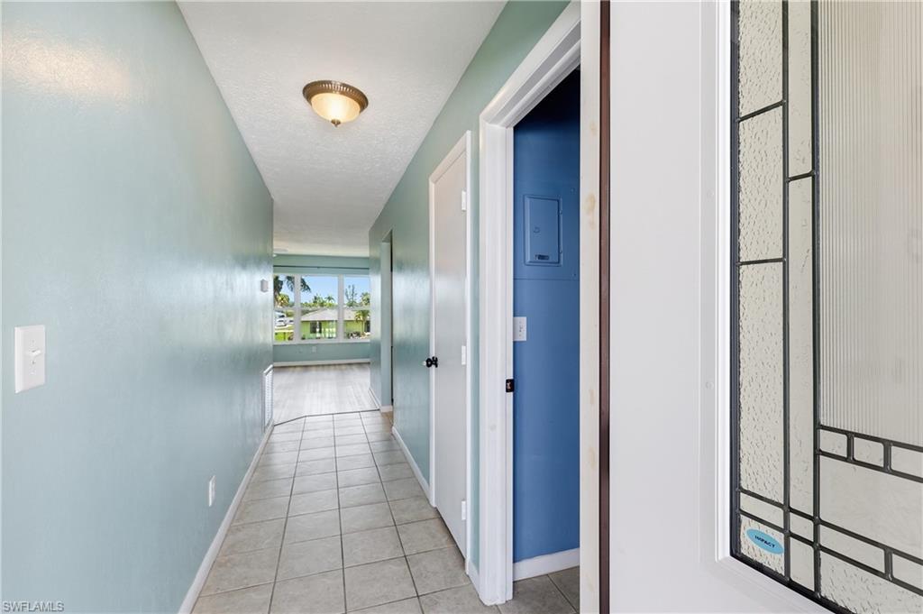 View when entering via front door. Laundry room is first door on the right, coat closet is next, and then the kitchen, followed by the dining room/living room and wonderful southern view.